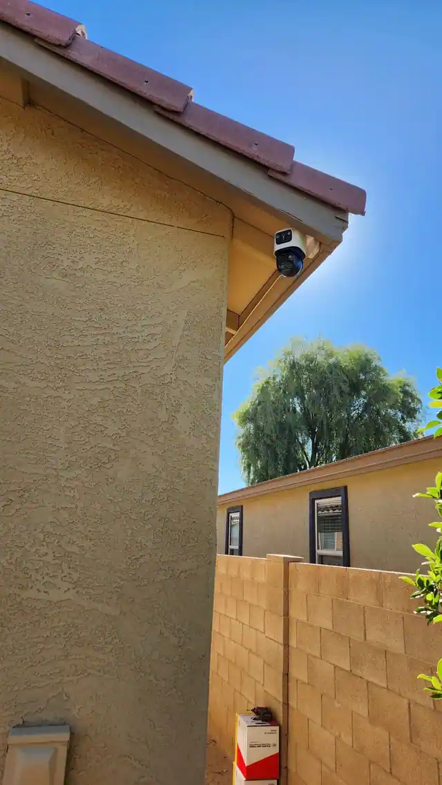 Dual-lens exterior camera installed at a roof corner