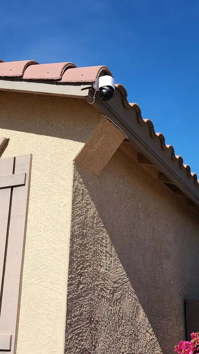 Pan-and-tilt camera mounted along a tile roofline