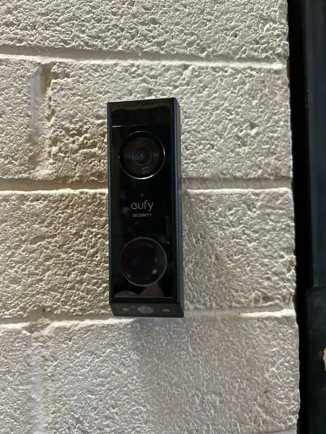 Eufy video doorbell mounted beside an exterior entry